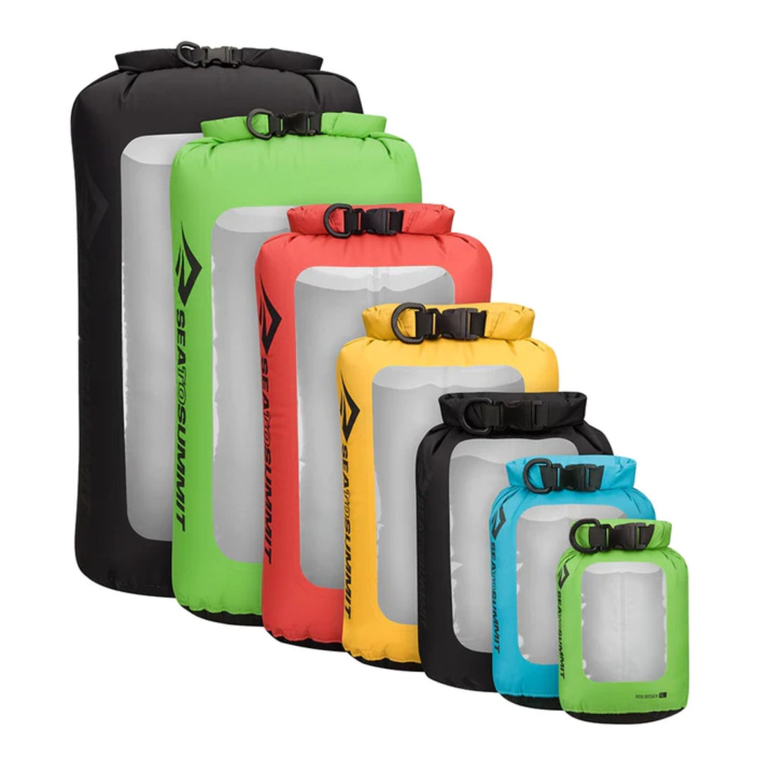 A range of Sea to Summit View Dry Sacks in various sizes and colors, including black, green, red, yellow, blue, and white, all with roll-top closures and TPU windows.